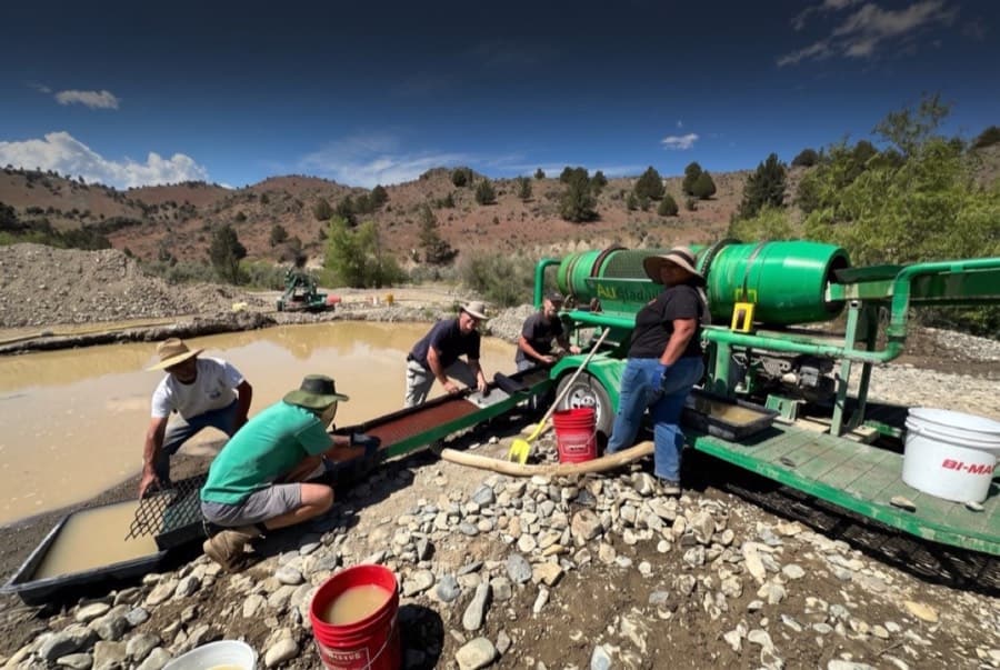 LDMA members running a trommel and sluice at camp